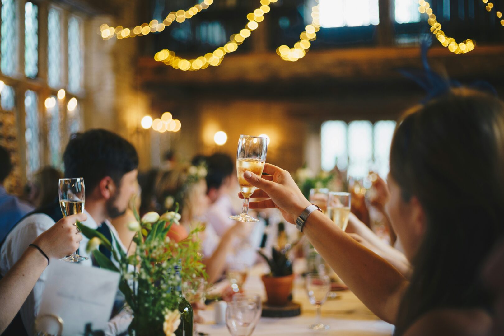 People raising glasses of sparkling wine.